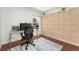 Bright home office with custom shelving, large window, and modern desk setup at 9376 W Wagon Trail Cir, Littleton, CO 80123