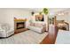 Bright living room featuring a fireplace, hardwood floors, and seamless flow to the outdoor patio at 9376 W Wagon Trail Cir, Littleton, CO 80123