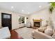 Cozy living room showcasing a fireplace, large window, and comfortable seating arrangement at 9376 W Wagon Trail Cir, Littleton, CO 80123