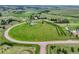 Aerial view of the home on a sprawling lot with mature trees and an access road at 43793 Buckskin Rd, Parker, CO 80138