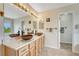 Bathroom with double sinks, granite counters, and a door leading to another room at 43793 Buckskin Rd, Parker, CO 80138