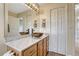 Bright bathroom featuring a stylish vessel sink, stone countertops, and a large mirror with vanity lights at 43793 Buckskin Rd, Parker, CO 80138