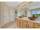Bright bathroom with double sinks, granite counters, and neutral carpet at 43793 Buckskin Rd, Parker, CO 80138
