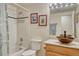 Bright bathroom with white tile, a bathtub, decorative wall art, a vessel sink, and updated fixtures at 43793 Buckskin Rd, Parker, CO 80138