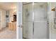 Bathroom with glass shower doors, double sinks, and neutral carpet at 43793 Buckskin Rd, Parker, CO 80138