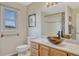 Bathroom featuring granite counters and natural wood vanity with a view to the outside at 43793 Buckskin Rd, Parker, CO 80138