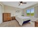 Bedroom with a ceiling fan and large window with a view of the surrounding green space at 43793 Buckskin Rd, Parker, CO 80138