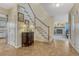 Warm entryway with tile flooring, a staircase, and a view into the living room with fireplace at 43793 Buckskin Rd, Parker, CO 80138