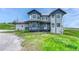 Charming two-story home with a covered porch, gray siding, and dark blue accents at 43793 Buckskin Rd, Parker, CO 80138