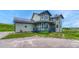 View of two-story home with gray siding, dark blue accents and a front yard at 43793 Buckskin Rd, Parker, CO 80138