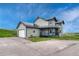 View of two-story home with gray siding, dark blue accents and a front yard at 43793 Buckskin Rd, Parker, CO 80138