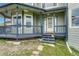 Inviting front porch with blue railings, gray siding, and a charming entrance at 43793 Buckskin Rd, Parker, CO 80138