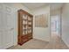 Inviting hallway featuring a prominent bookshelf with glass doors and a map on the wall at 43793 Buckskin Rd, Parker, CO 80138