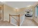Upper hallway featuring a staircase and a glimpse into a bedroom, creating a welcoming transition space at 43793 Buckskin Rd, Parker, CO 80138
