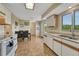 Open-concept kitchen and dining area with ample counter space and natural light, perfect for culinary enthusiasts at 43793 Buckskin Rd, Parker, CO 80138