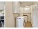Convenient laundry room with modern appliances and ample storage space, streamlining household chores at 43793 Buckskin Rd, Parker, CO 80138