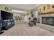 Inviting living room featuring a brick fireplace, a cozy recliner, and seamless access to the dining area at 43793 Buckskin Rd, Parker, CO 80138