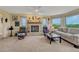 Cozy living room with brick fireplace, neutral carpet, and large windows with a view at 43793 Buckskin Rd, Parker, CO 80138