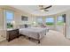 Spacious main bedroom with a seating area, ceiling fan, and views of the green space at 43793 Buckskin Rd, Parker, CO 80138