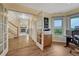 Spacious office with wood floors, a window with a view, and a glimpse of the living room at 43793 Buckskin Rd, Parker, CO 80138