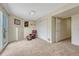 Carpeted bonus room with sliding glass doors and a cozy sitting area featuring a red leather recliner at 43793 Buckskin Rd, Parker, CO 80138