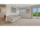 Comfortable living room with a cozy couch, a window, and natural light pouring in from the sliding glass doors at 43793 Buckskin Rd, Parker, CO 80138