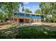 Large backyard with patio, covered pergola, and mature trees at 3824 S Xenia St, Denver, CO 80237