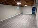 Unfinished basement with neutral walls and new vinyl flooring at 3824 S Xenia St, Denver, CO 80237