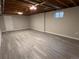 Unfinished basement with neutral walls and new vinyl flooring at 3824 S Xenia St, Denver, CO 80237