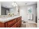 Bathroom with double vanity, granite countertops, and updated fixtures at 3824 S Xenia St, Denver, CO 80237