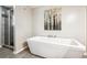 Modern bathroom with a free-standing soaking tub and walk-in shower at 3824 S Xenia St, Denver, CO 80237