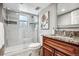 Basement bathroom with shower, granite vanity, and updated fixtures at 3824 S Xenia St, Denver, CO 80237