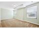 Spacious basement bedroom with carpet and two large windows at 3824 S Xenia St, Denver, CO 80237