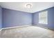 Light and airy bedroom with neutral walls and carpeted floors at 3824 S Xenia St, Denver, CO 80237