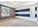 Bedroom with navy and white accent wall and neutral carpet at 3824 S Xenia St, Denver, CO 80237