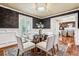 Elegant dining room with dark walls, wainscoting, and a glass top table at 3824 S Xenia St, Denver, CO 80237