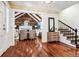 Bright entryway with hardwood floors, open staircase, and view of living room at 3824 S Xenia St, Denver, CO 80237