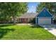 Ranch style home with blue siding, red door, and a well-manicured lawn at 3824 S Xenia St, Denver, CO 80237