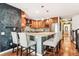 Modern kitchen with granite countertops, wood cabinets, and breakfast bar at 3824 S Xenia St, Denver, CO 80237