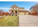 Two-story house with attached three-car garage and well-manicured lawn at 492 N Jackson Gap Way, Aurora, CO 80018