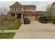 Two-story house with attached two-car garage and landscaped yard at 492 N Jackson Gap Way, Aurora, CO 80018