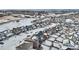 Snowy aerial view of a residential neighborhood showcasing charming homes and winter landscapes at 5044 Basalt Ridge Cir, Castle Rock, CO 80108