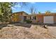 Ranch style home with brick exterior, attached garage, and landscaping at 14066 E 27Th Ave, Aurora, CO 80011