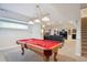Finished basement featuring a billiards table, fireplace, and living room area at 15573 E Prentice Ln, Centennial, CO 80015