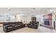 The finished basement has a brick fireplace, built-in shelves, and seating for entertaining at 15573 E Prentice Ln, Centennial, CO 80015