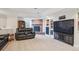 Finished basement with a brick fireplace, built-in shelves, and comfortable seating area at 15573 E Prentice Ln, Centennial, CO 80015