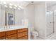 Updated bathroom with oak cabinets, marble vanity top, and a fully enclosed glass shower at 15573 E Prentice Ln, Centennial, CO 80015