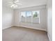 Bright bedroom featuring neutral walls and carpet, and natural light from the windows at 15573 E Prentice Ln, Centennial, CO 80015