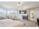 Relaxing main bedroom boasts a fireplace, soft carpet, and access to an en-suite bathroom for ultimate comfort at 15573 E Prentice Ln, Centennial, CO 80015