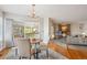 Cozy dining area with a chandelier, access to the deck, and views of the fireplace at 15573 E Prentice Ln, Centennial, CO 80015